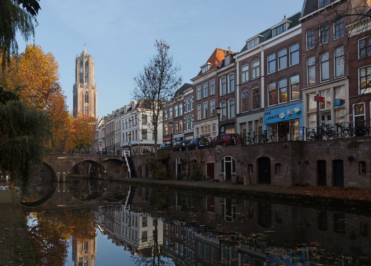 The Oudegracht canal in Utrecht with wharf cellars at water level and the Dom Tower behind